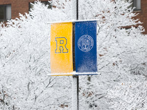 A yellow and blue banner featuring the letter "R," representing the University of Rochester.